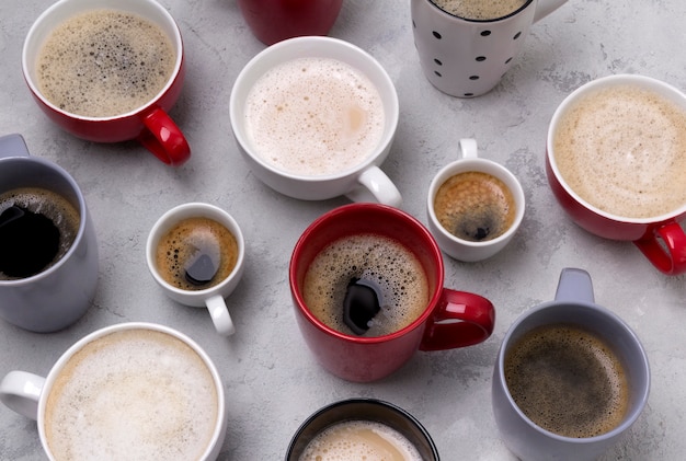 Various coffee in different cups on the concrete gray table