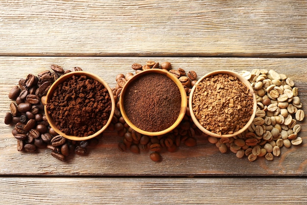 Various of coffee in small dishes on wooden table, top view