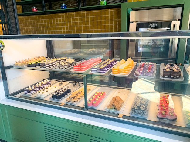 Various colored cakes on plates. Sweet desserts. Studio Photo