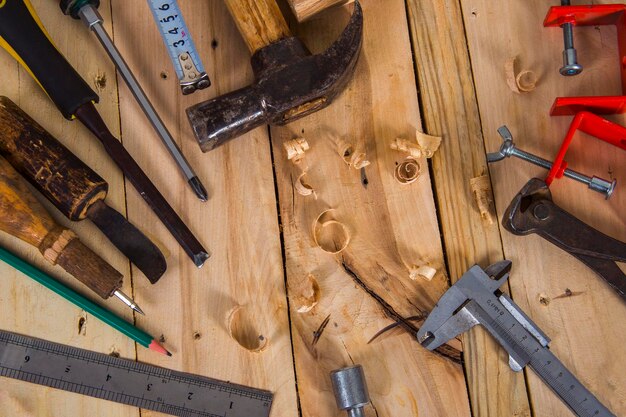 Various construction tools with hand tools for home renovation on wooden board