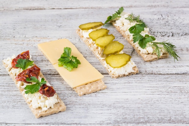 Various crispbread slices on woden kitchen table top view