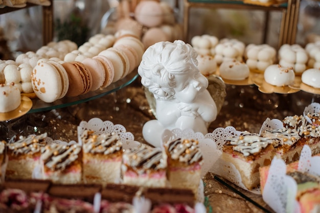 Various desserts and cake on the buffet table at the wedding