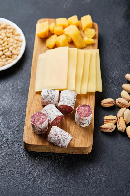 Various gourmet wine snacks. Hard cheese, young cheese and duck sausage. Italian snacks for an important holiday.