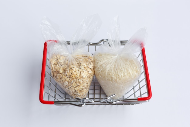 Various groats in packages in grocery basket