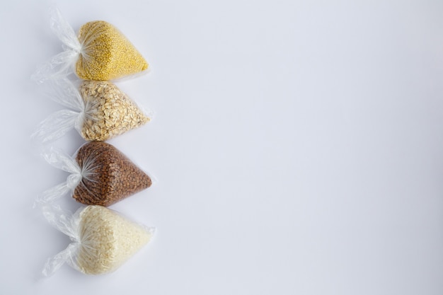 Various groats in small plastic bags Rice and oatmeal buckwheat and millet