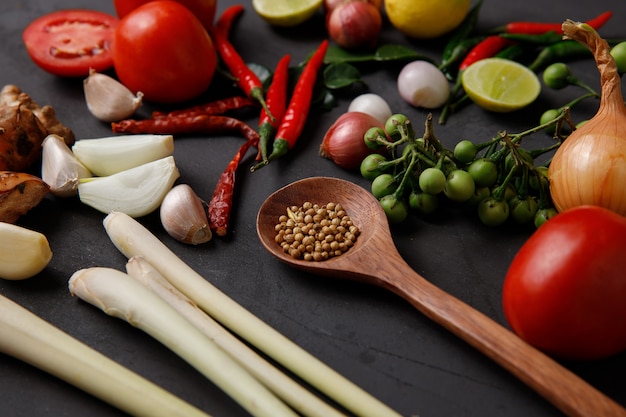 Various herbs and Ingredients to cook on dark background.