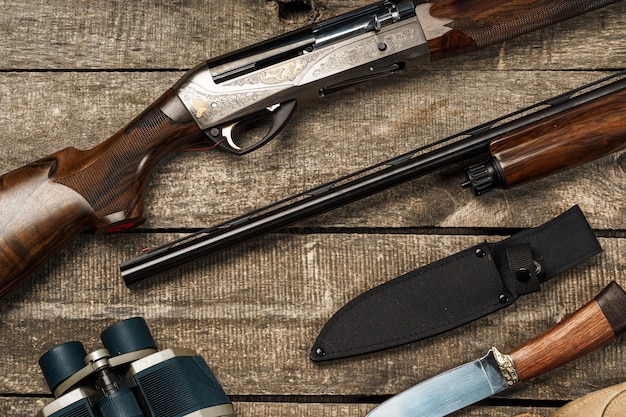 Various hunting equipment on old wooden background