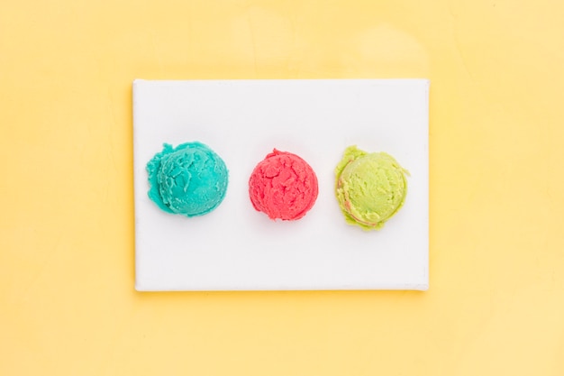 Various ice cream balls on white board