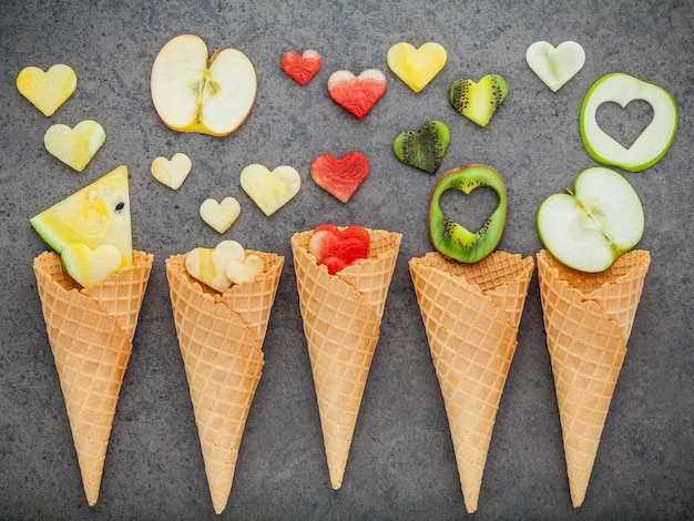 Various of ice cream flavor in cones setup on dark stone background . 