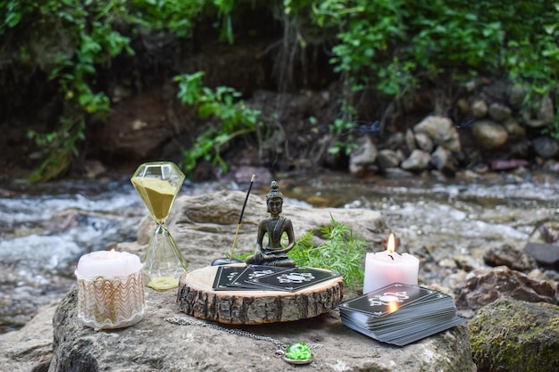 Various items for rituals and divination on a large stone on the background of a mountain river