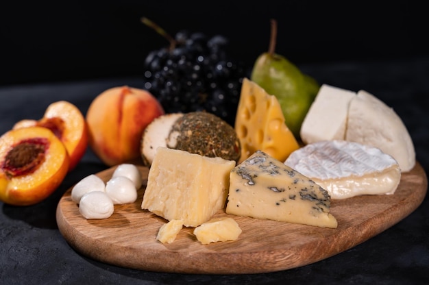 Various kinds of cheese with walnuts and grapes