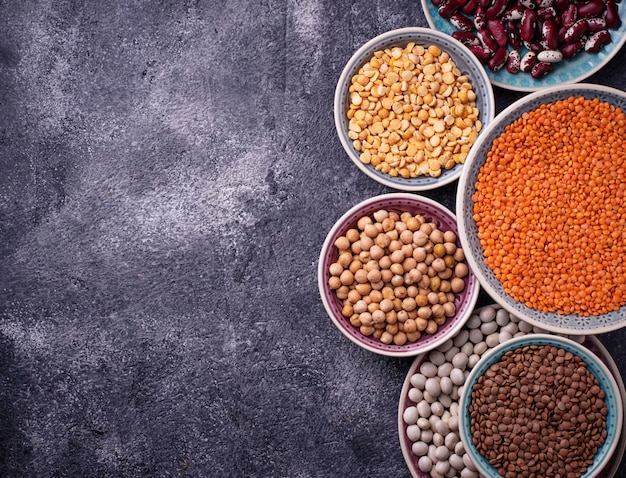 Various legumes. Chickpeas, red lentils, black lentils, yellow peas and beans. Selective focus. Top 