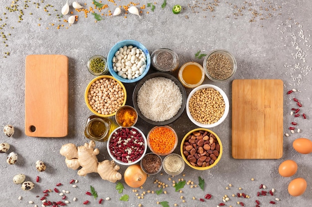 Various legumes and seeds and olive oil with cutting boards