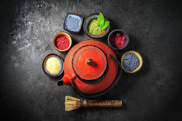 Various matcha tea powders on a dark concrete