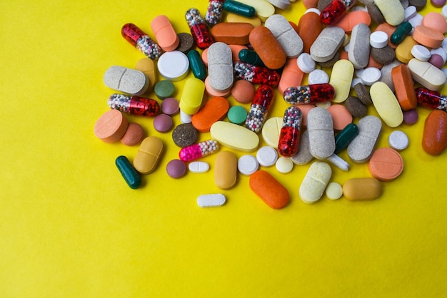 various medicines on yellow background