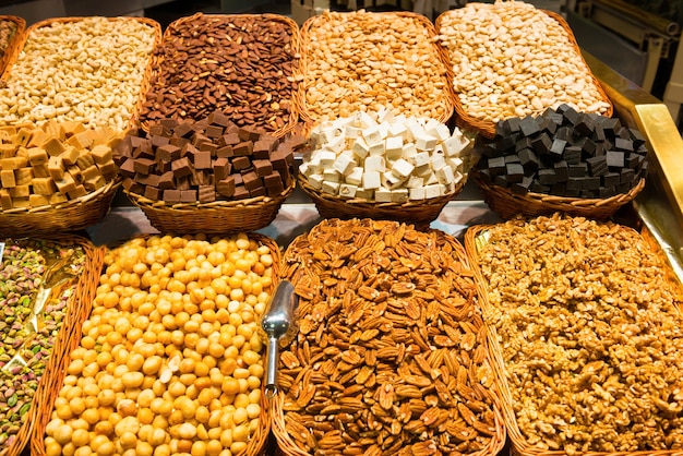 Various nuts in wooden baskets for sale at market