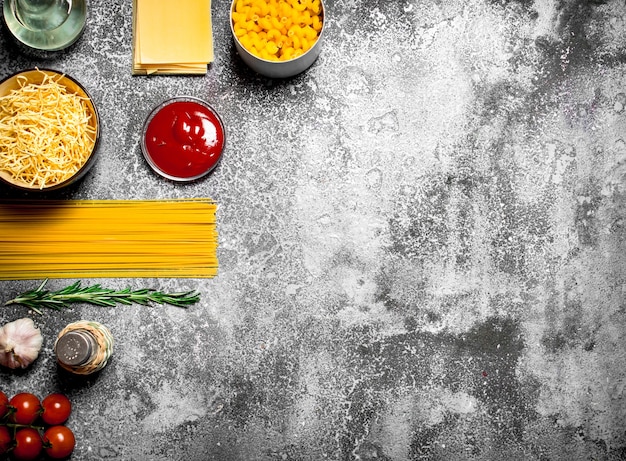 Various pasta with tomato sauce , spices and rosemary.