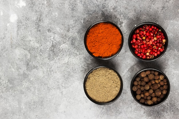 Various pepper on a gray background. Top view, copy space. Food background