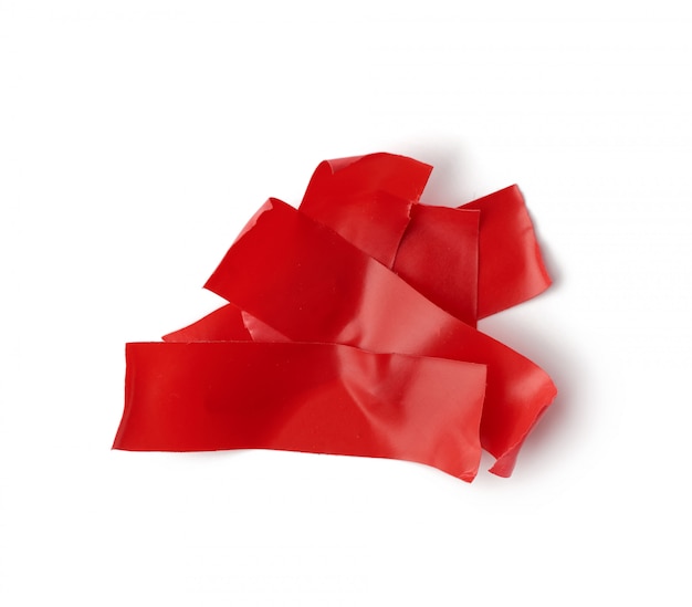 Various pieces of red insulating rubber tape isolated on a white background