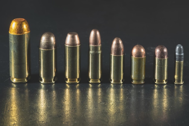 Various pistol cartridges from the weakest 22lr to the most powerful 50AE Closeup photo