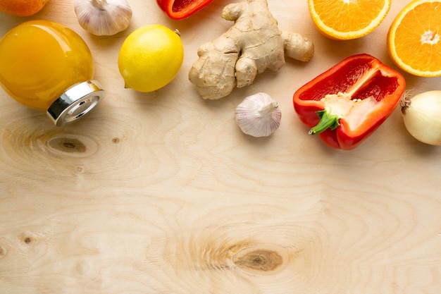 Various products for immunity boosting. Vegetable, fruit and honey on wooden background, copyspace