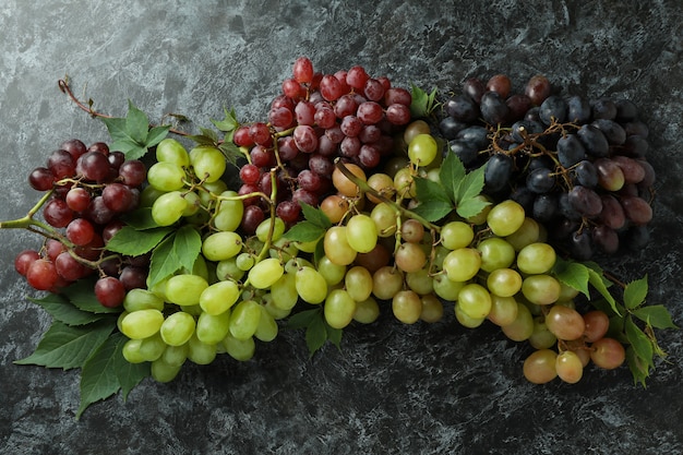 Various ripe grape on black smokey background