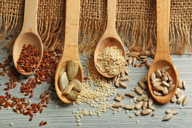 Various seeds on blue wooden background, closeup