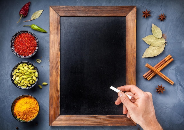 Various Spices near blackboard at blue stone background