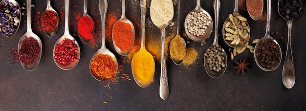 Various spices spoons on stone table