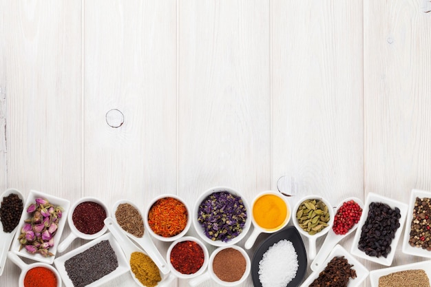 Various spices on white wooden background