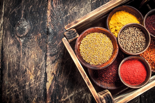 Various spicy spices and herbs. On a wooden table.