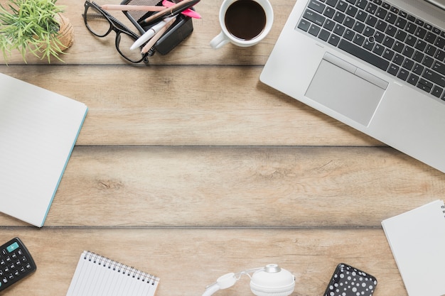 Various stationery near devices and coffee cup