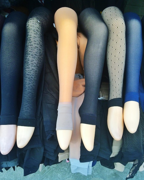 Photo various stocking in displayed in mannequins for sale at shop