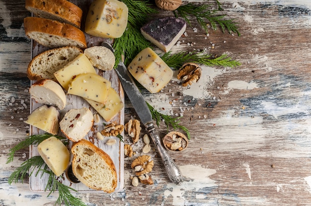 Various types of author's cheese on wood