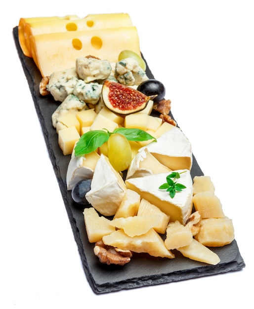 Various types of cheese on stone board