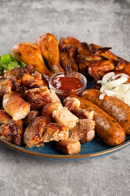 Various types of grilled meat in a plate on the table