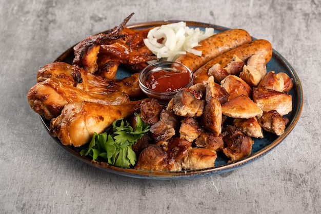 Various types of grilled meat in a plate on the table