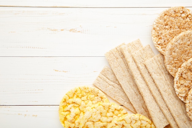 Various types of healthy whole grain crispbreads on white.