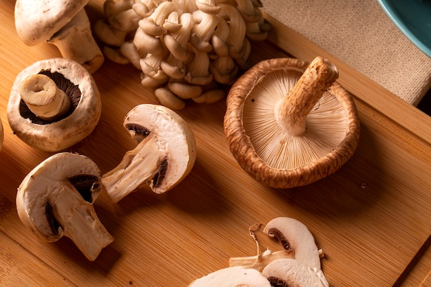 Various types of mushrooms on a wooden table.