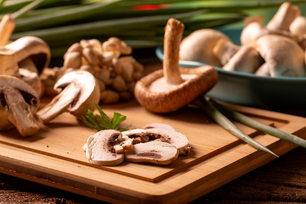 Various types of mushrooms on a wooden table.