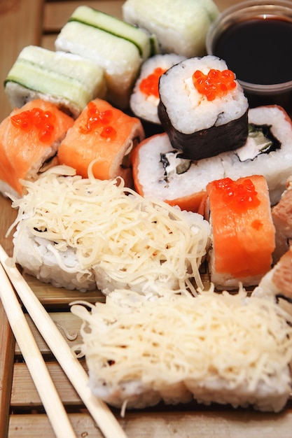 Various types of rolls are served on a wooden table Sushi menu for Japanese cuisine