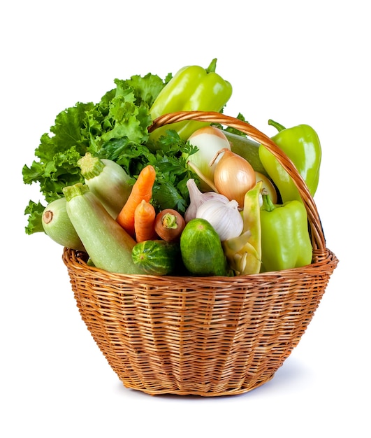 Various vegetables in a wicker basket isolate on white, fresh food