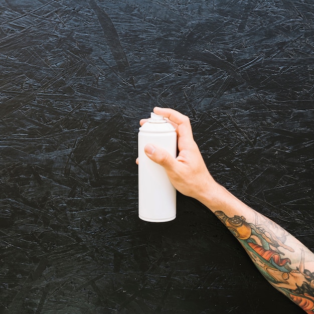 Various white bottles in a row on rough black surface