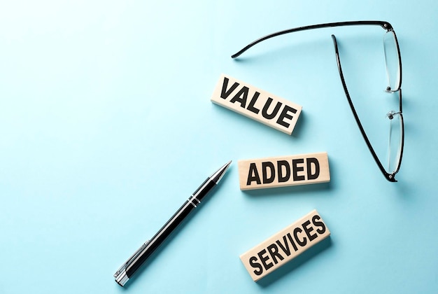 VAS Value Added Services text on the wooden block blue background