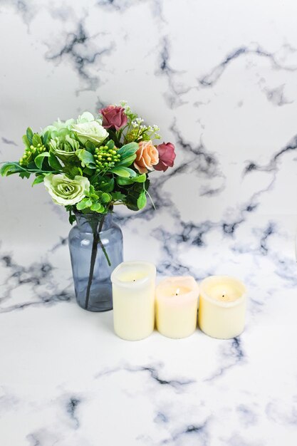 Photo the vase of bouquet of flowers and white candle scent sensory home decoration and self pampering concept