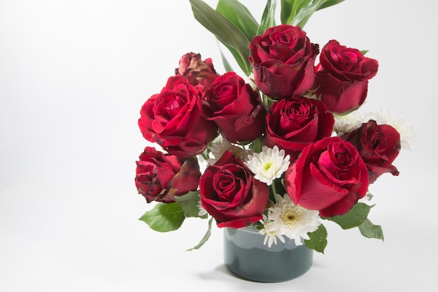 Vase of bouquet red Roses in aluminium bucket on white background.