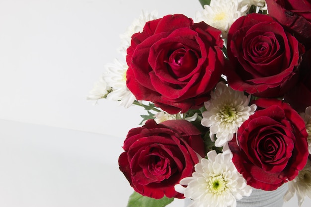 Vase of bouquet red Roses in aluminium bucket on white background.