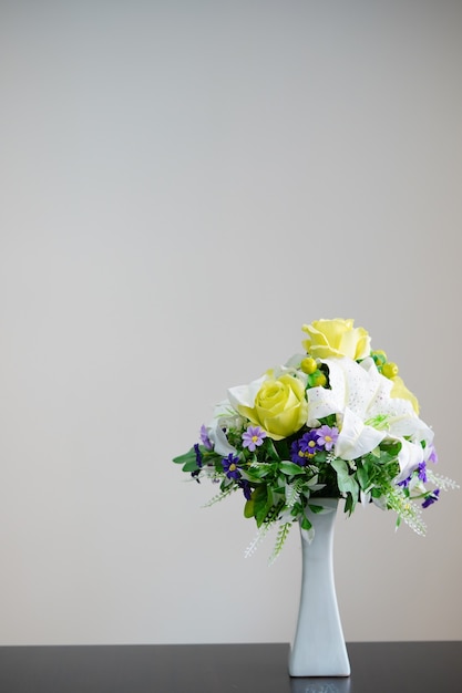 vase of flowers decorated on white background with space for text