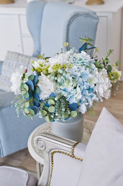 Vase of flowers on the table in the room. 