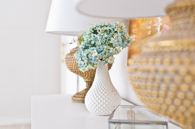 Vase of flowers on the table in the room.